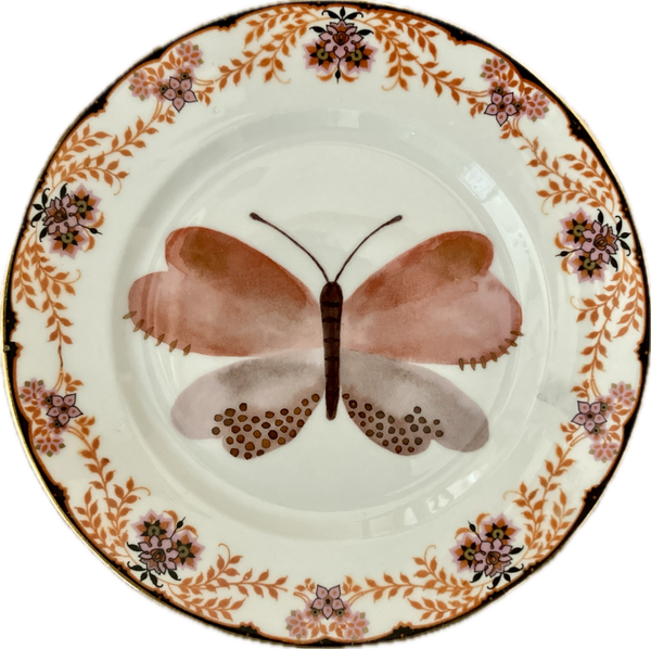Vlinder op bordje met decoratieve en gouden rand