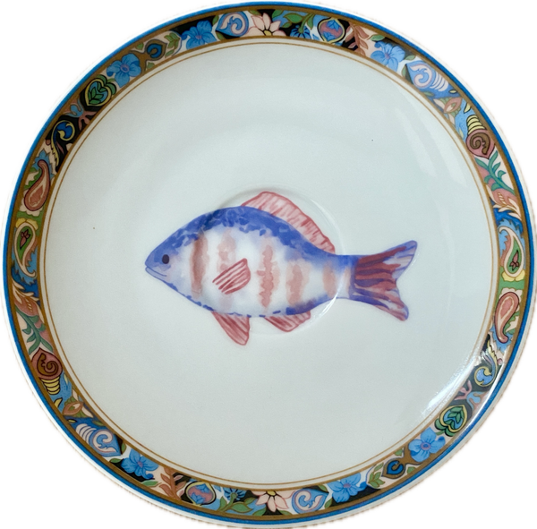 Blauwe vis op schotel met decoratieve rand