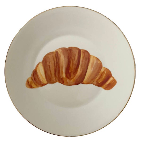 Croissant op bordje met gouden rand