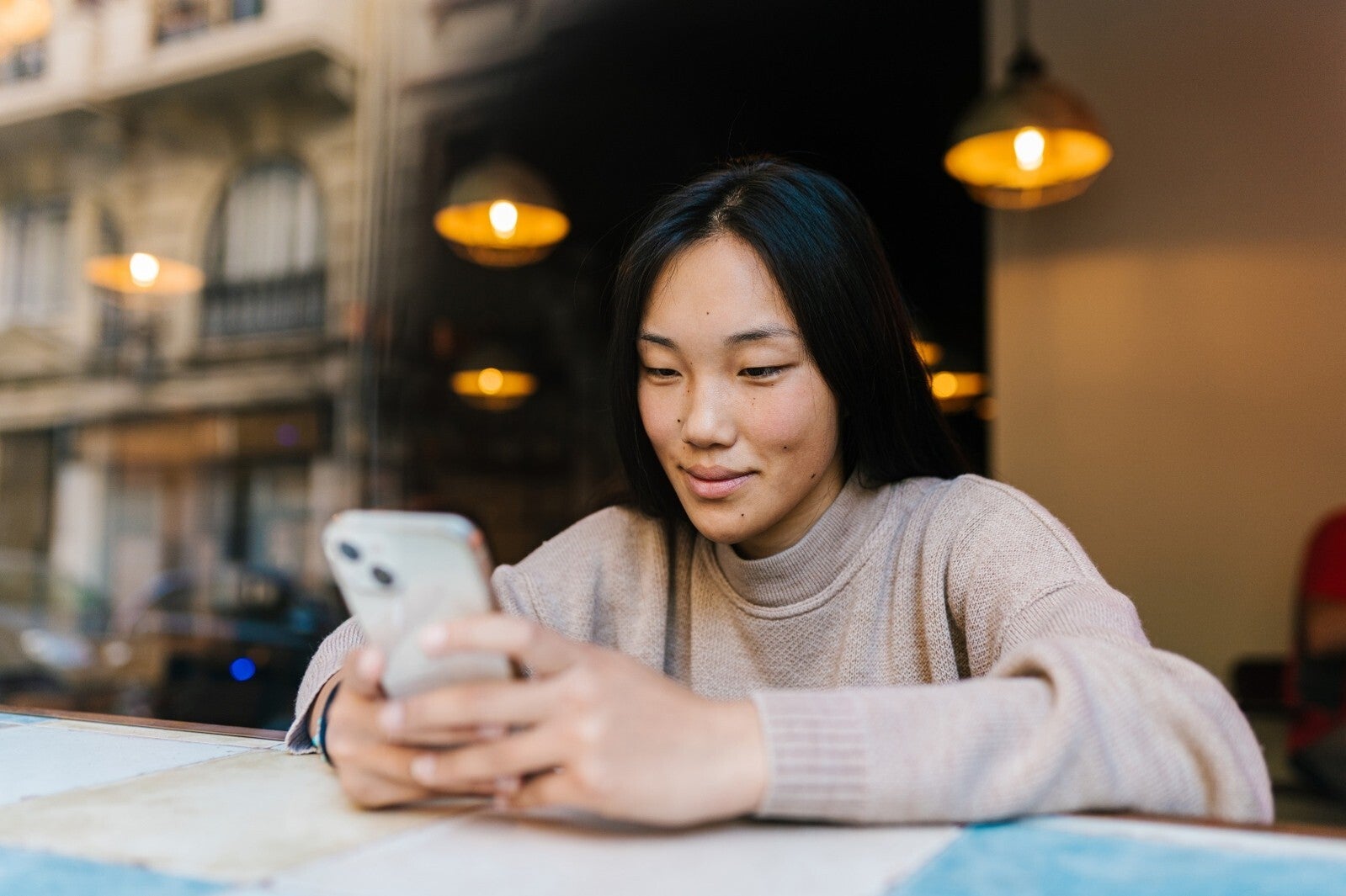 Happy woman looking at phone screen