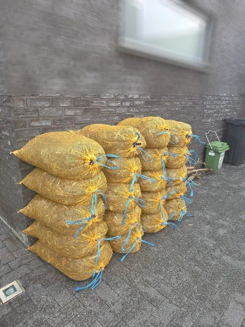 Zakken boomschors gestapeld op een oprit
