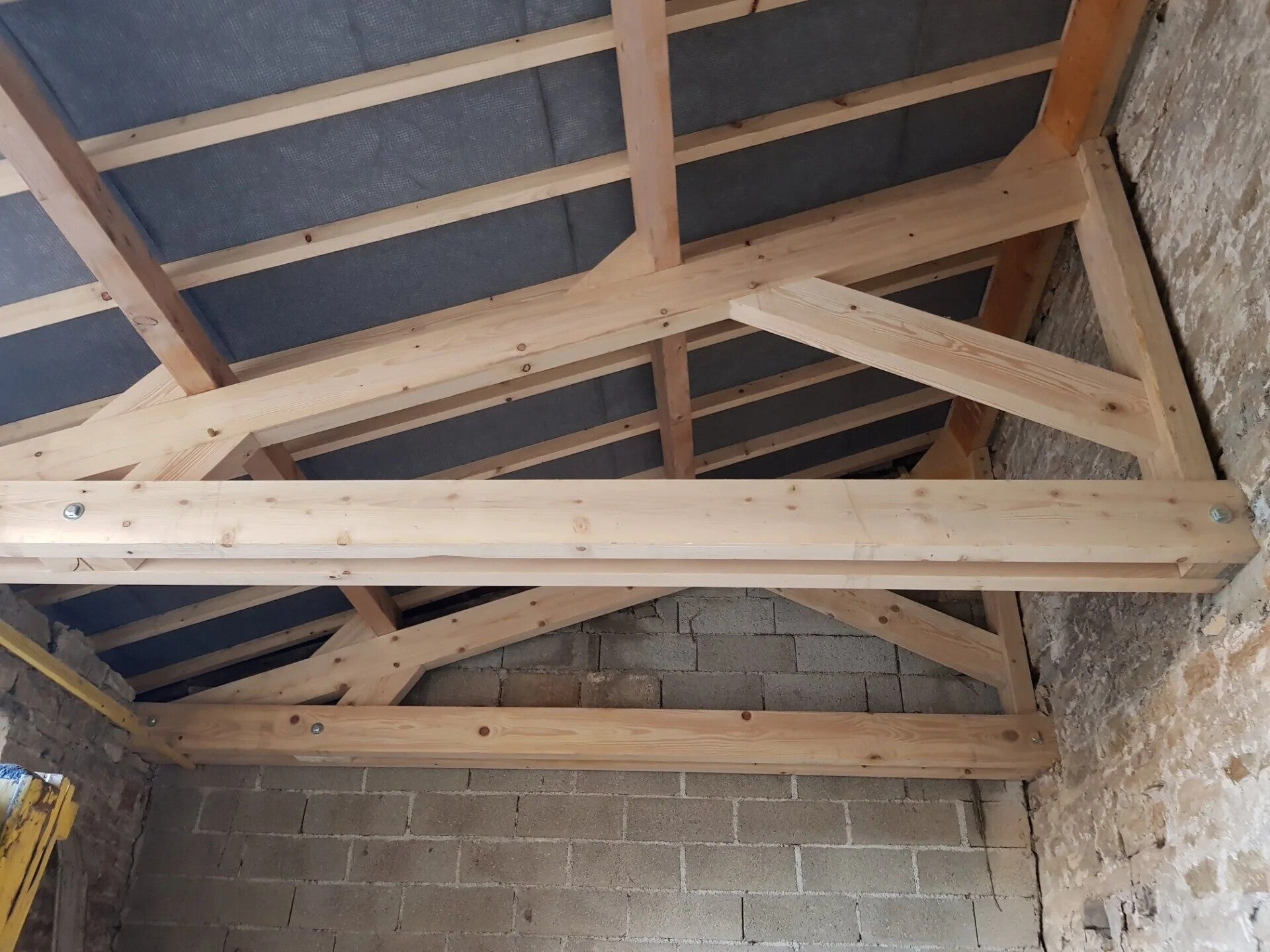 Charpente bois neuve à l’intérieur d’un bâtiment rénové à Meursault.
