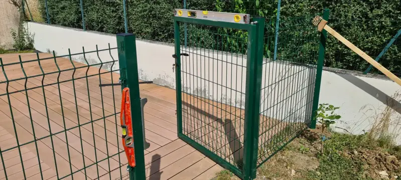 Portillon en grillage rigide installé autour d’une piscine à Saint-Bernard avec réglage et mise à niveau