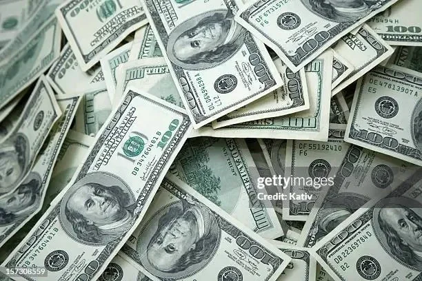 Close-up image of stacked one hundred dollar bills representing casino rewards, cruise value, and the hidden costs that may still apply to free casino cruise offers.