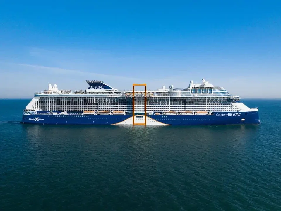 Evening casino floor onboard a cruise ship with table games and slot machines