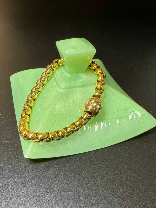 Radiant Gold Bracelet with Intricate Detailing and Gemstone Highlights