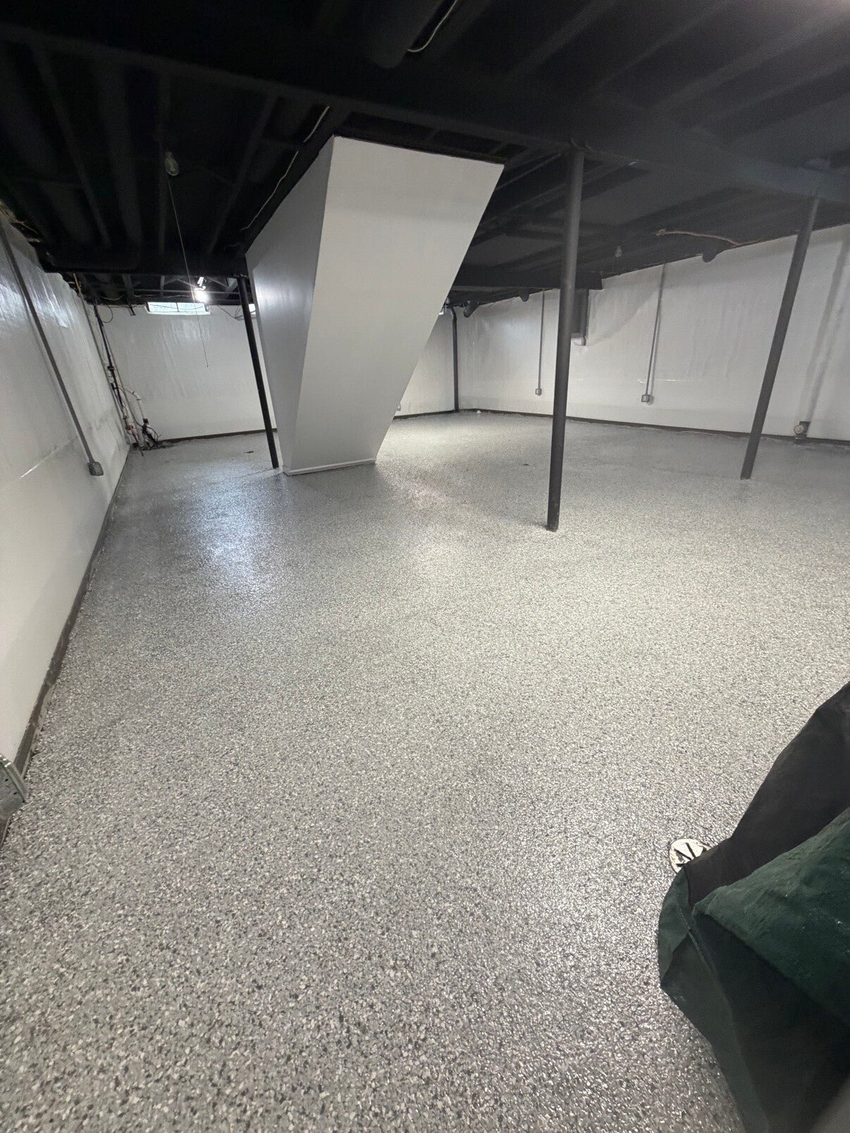 Light gray flake floor finish in a finished basement