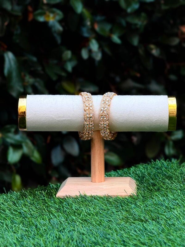 Four tear gold bangles