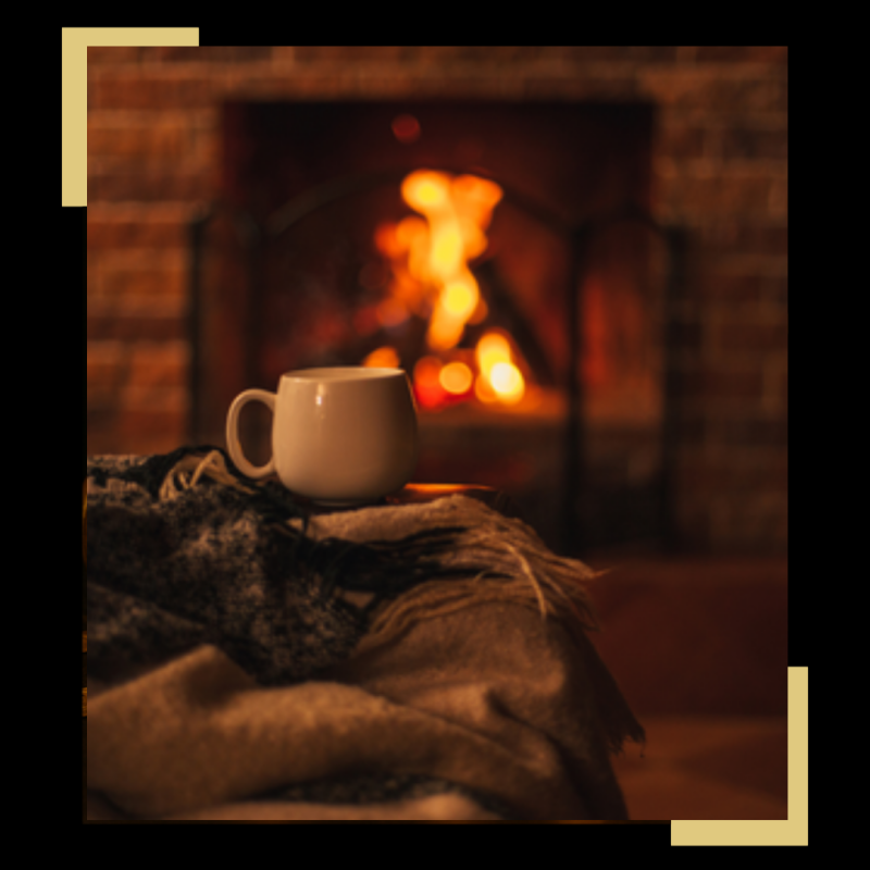 “Cosy fireplace scene with warm glowing flames, winter décor and luxury home fragrance styling.”
