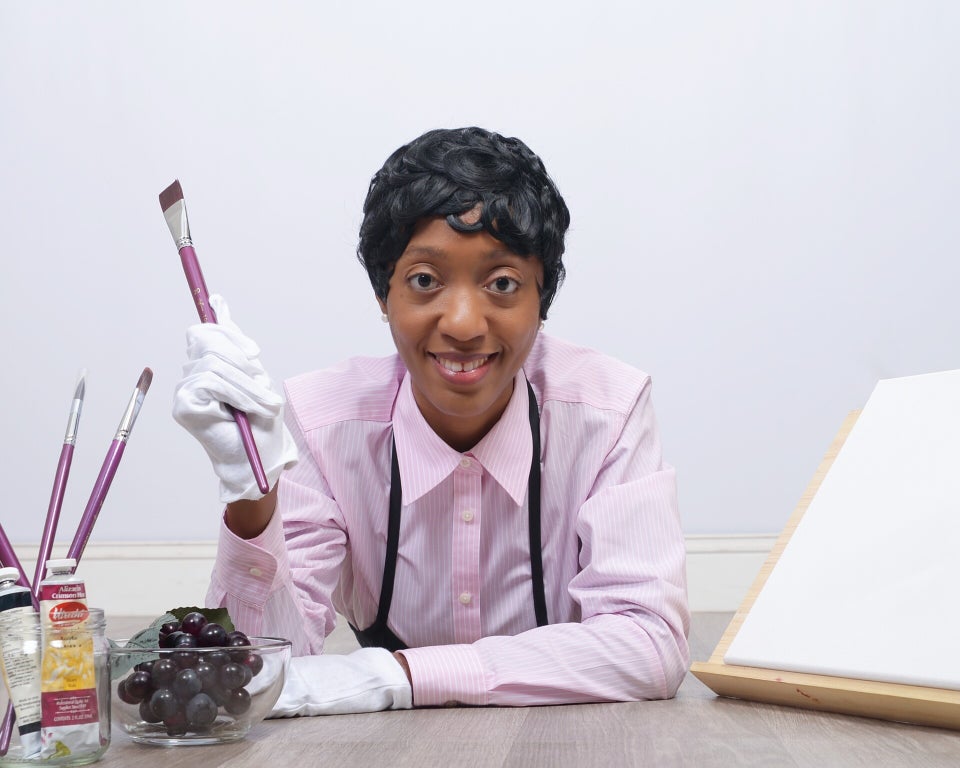 Photo of artist with colorful art back ground