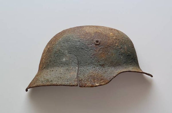 German helmet with visible 'camo' colours, cut in half as a wall item. (KURLAND)
