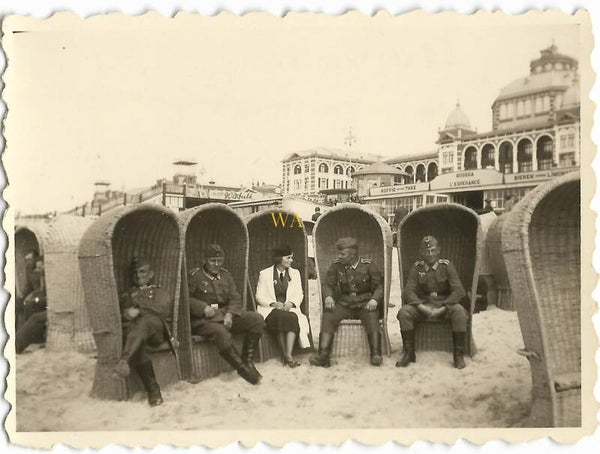 German soldiers and a Helferin in front of the Kuhrhaus in Scheveningen, Holland