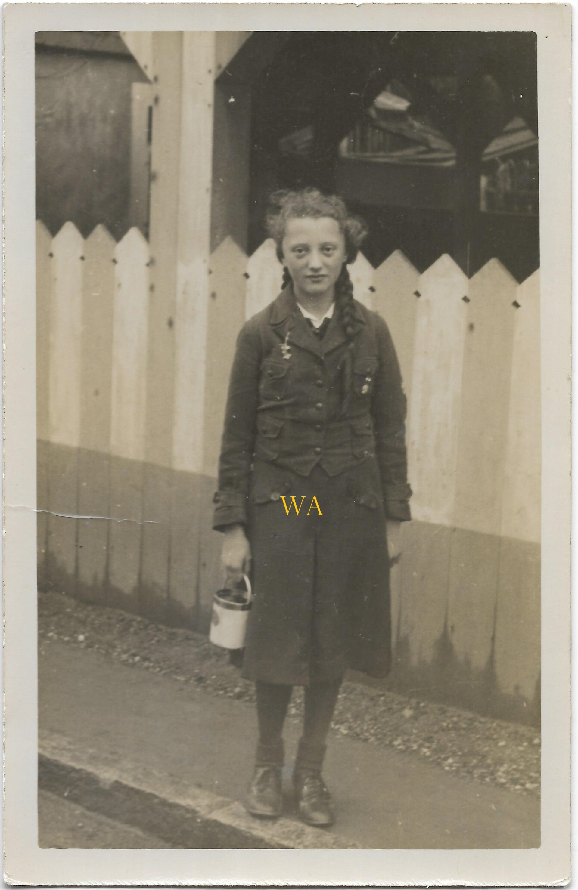 Large photograph of a BDM girl with pigtails and insignia pin.