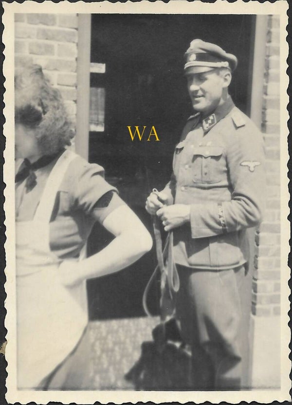 Photograph of an SS-Obersturmführer wearing an “Adolf Hitler” armband.