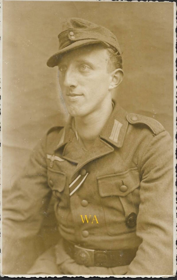 German Obergefreiter wearing an M43 field cap (standard field cap) with VWA and EK2