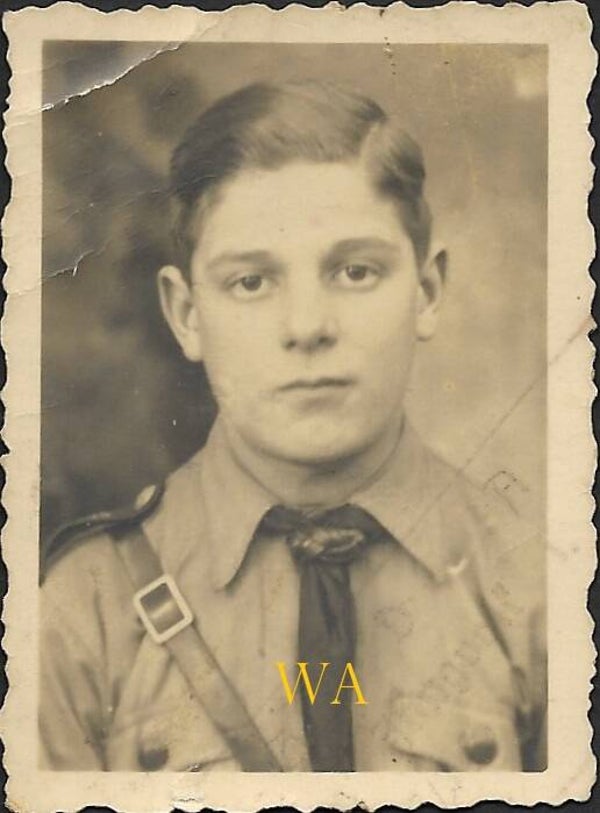 Passport photo of a member of the Hitler Youth wearing a belt and a leather scarf.