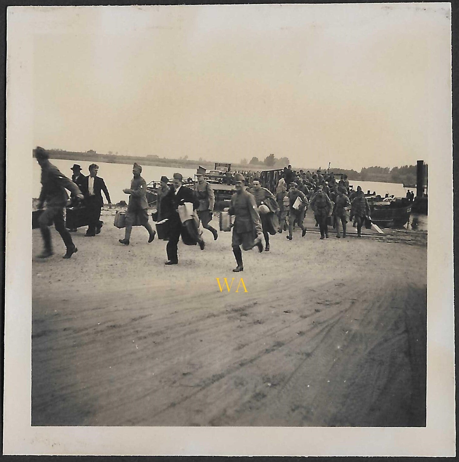 A group of Dutch soldiers running off the ferry, presumably on the Waal River near Nijmegen.