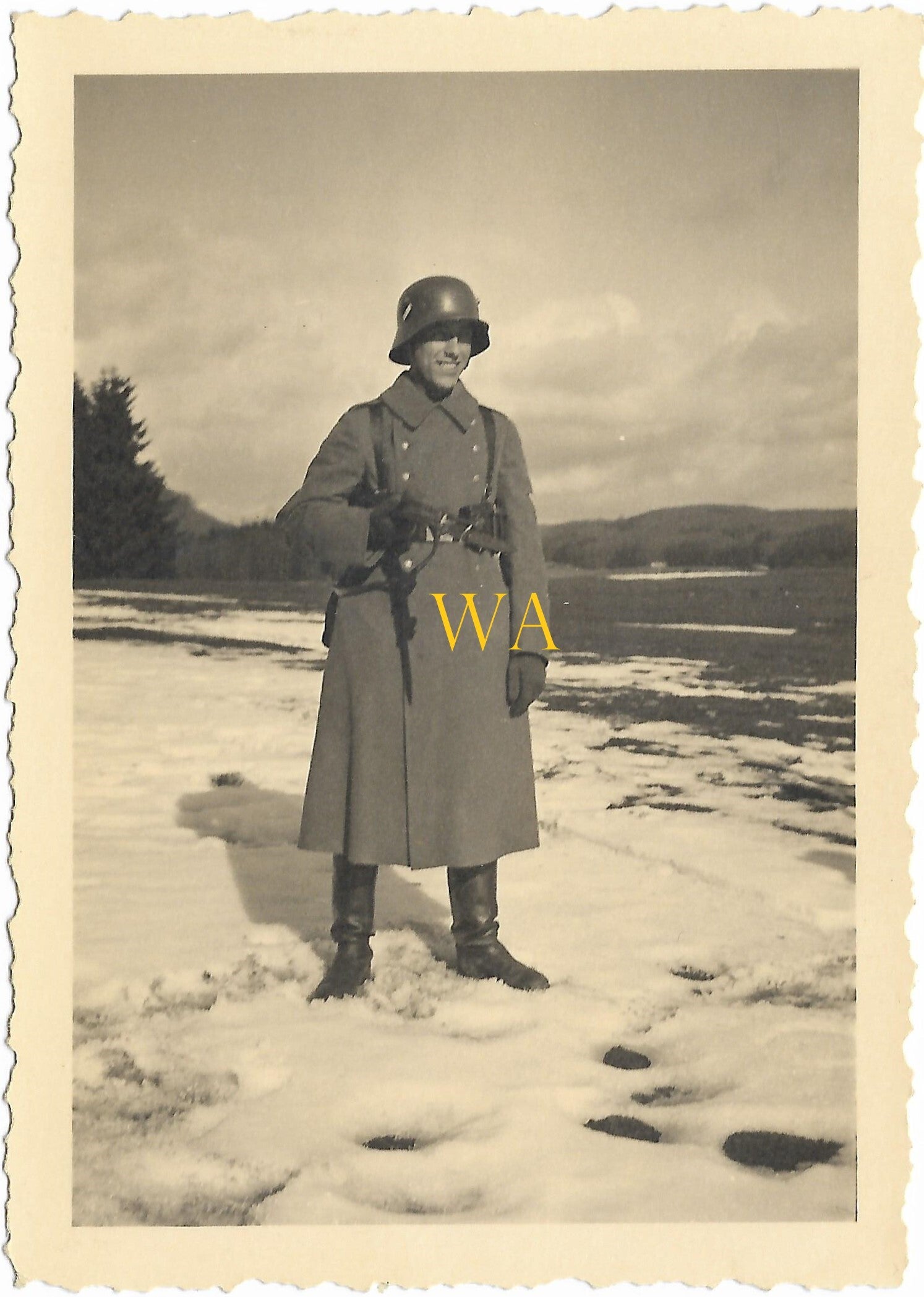 Steel helmet with long coat in low winter sun, 1936