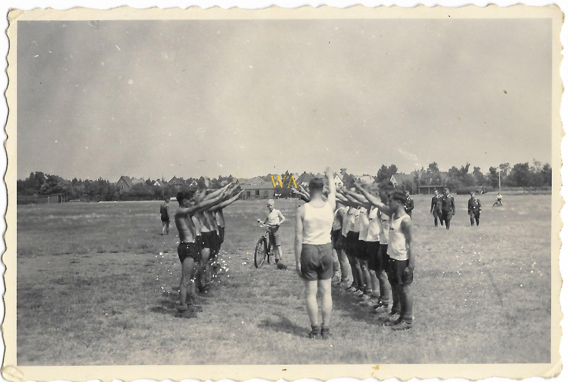 Group of Luftwaffe members in sports uniform bring Nazi salute.