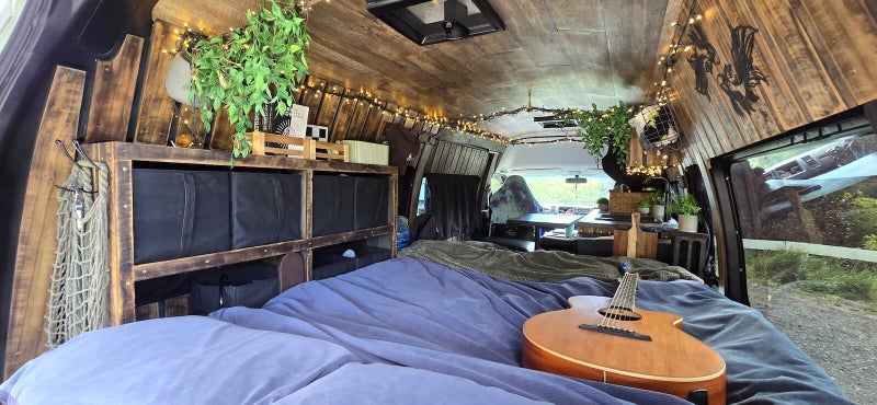Interior daytime view of the Poseidon campervan showing the luxury bed setup and back right side