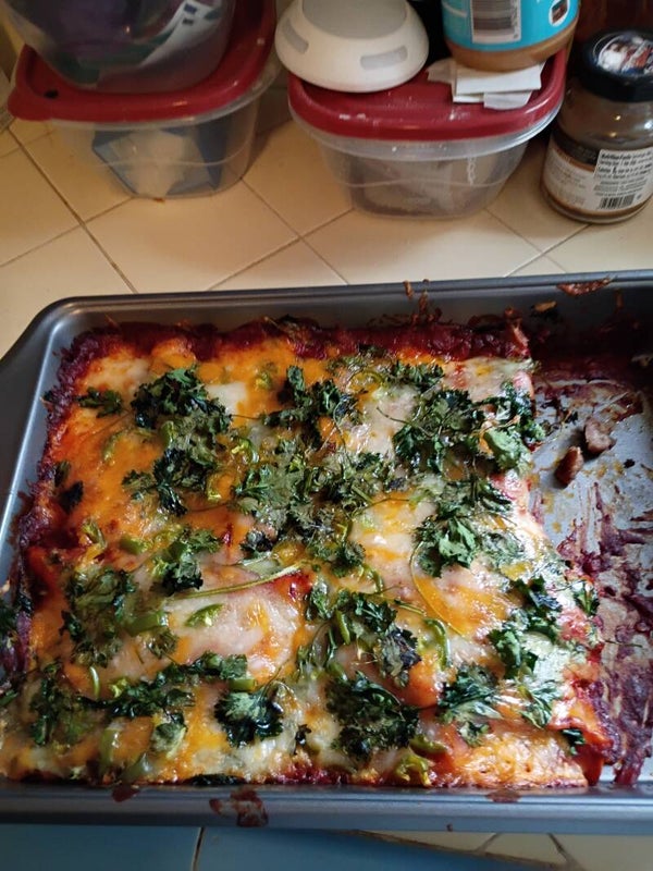 Wet burrito with red sauce and cilantro on top or just wet burrito with red sauce or enchilada red and green sauce