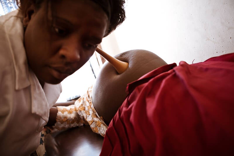 dr listens to heartbeat of unborn child, documentray photo,