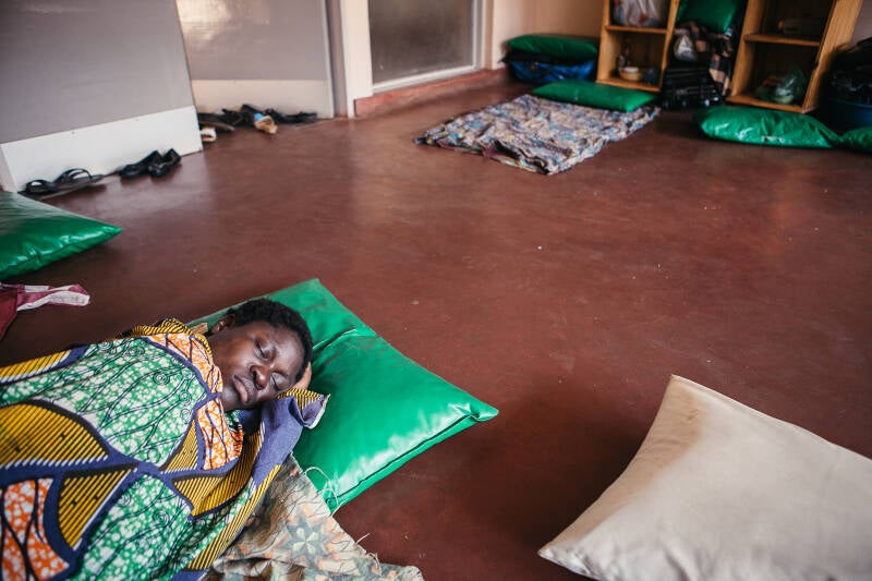 new african mother sleeps on ground, documentary photos by Paolo Patruno,