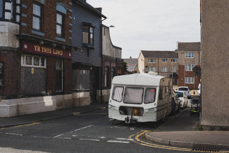 photographer Jose Baker records a pub and derelict caravan dumped on the streets of angelsey in this report of the town strugglin economically, 