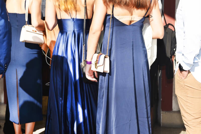 girls in tight dresses wait in line, photos by documentary photographers,