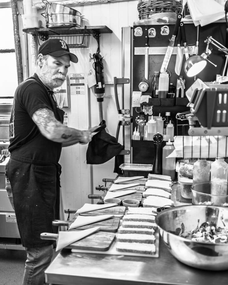 a barista makes a coffee in this documentary photo,