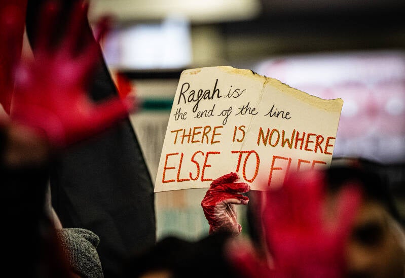 blood covered hands, painted in, are used for effect during the Gaza protests in Manchester, England,