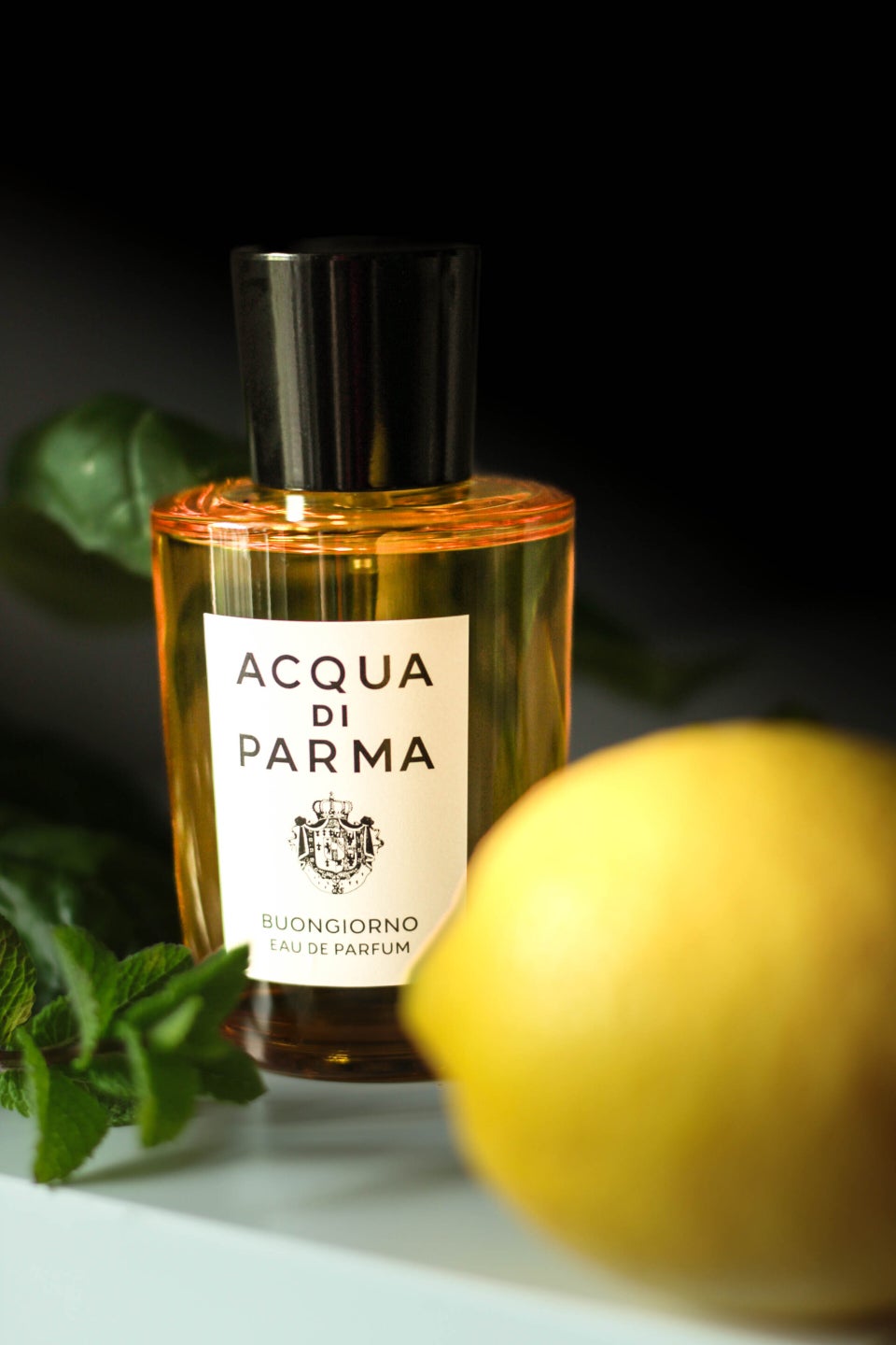 Minimalistic still life with lemon, mint and luxury perfume
