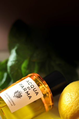 Acqua di Parma scent placed beside Mediterranean ingredients