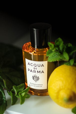 Perfume bottle of Buongiorno styled with fresh lemon and mint