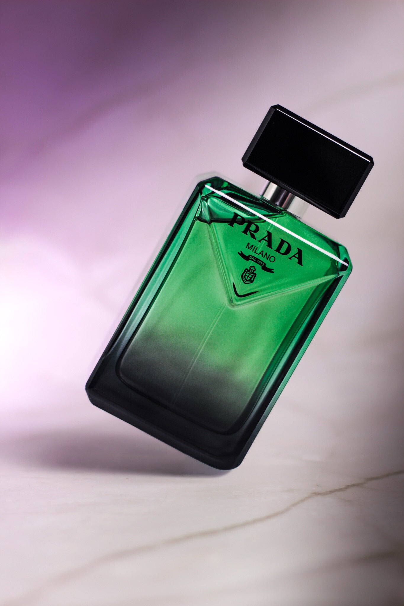 Prada Paradigme fragrance photographed in a green reflective bottle for a luxury perfume review.