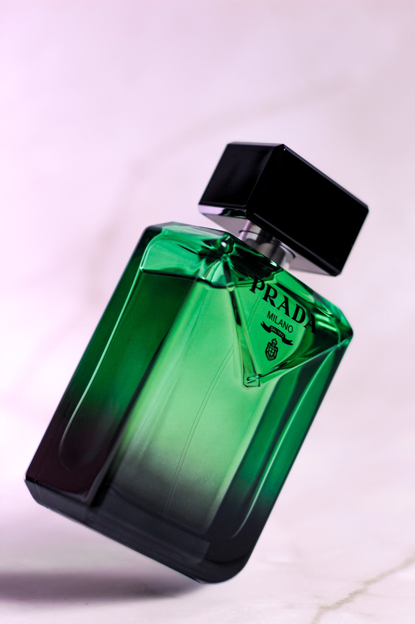 Luxury photo of Prada Paradigme highlighting its deep green gradient glass and bold black cap