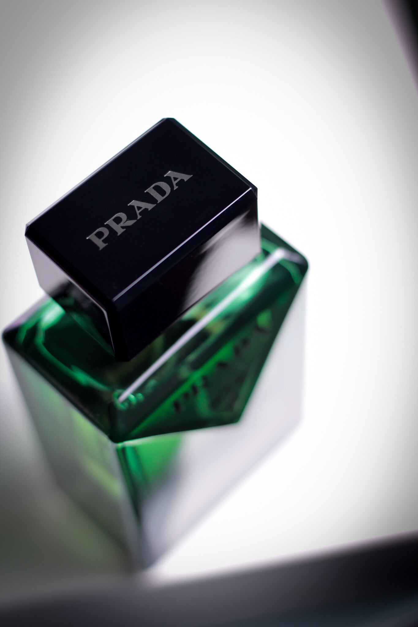 Luxury fragrance photo of Prada Paradigme with a detailed view of the cap and angular bottle design.