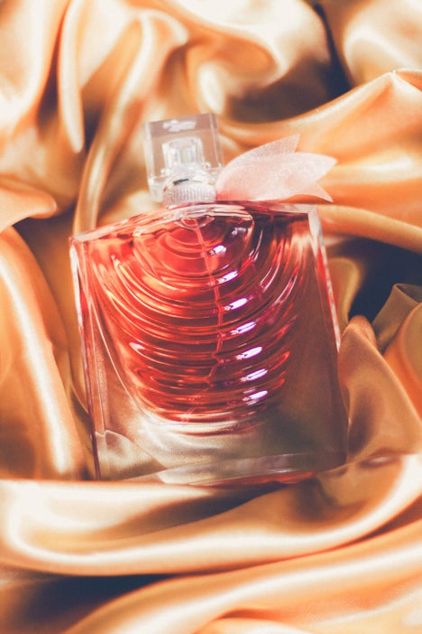 Golden-toned flat lay of Lancome La Vie Est Belle Iris Absolu perfume