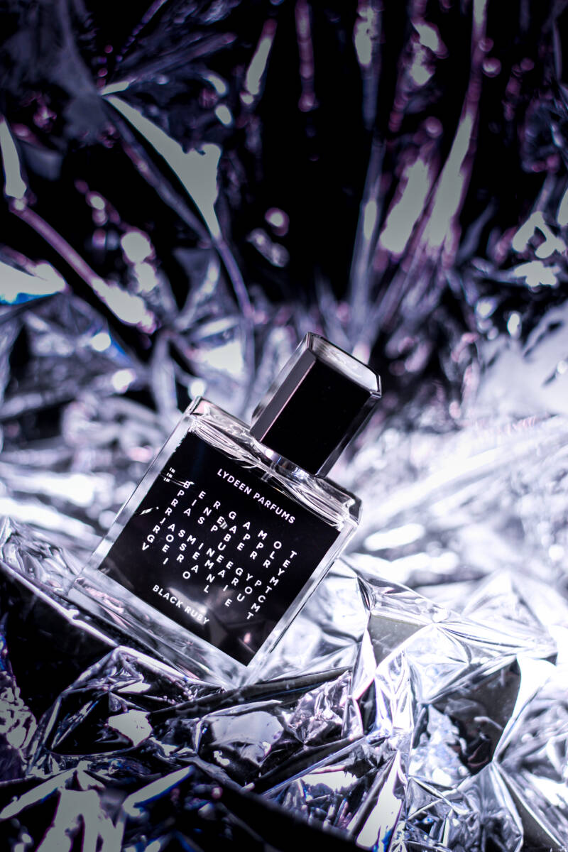 1. Fragrance bottle on silver crinkled surface