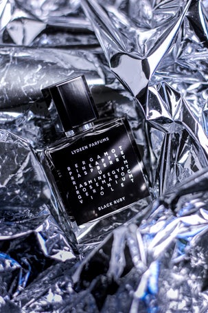 2. Bold black square perfume bottle styled artistically