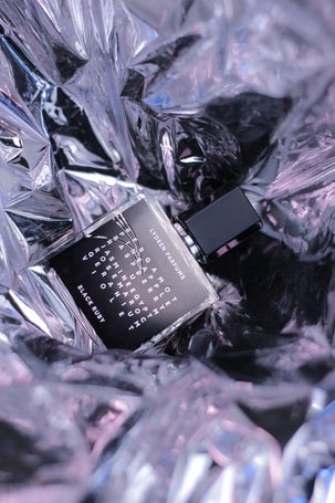 1. Intriguing lighting around a mysterious fragrance bottle