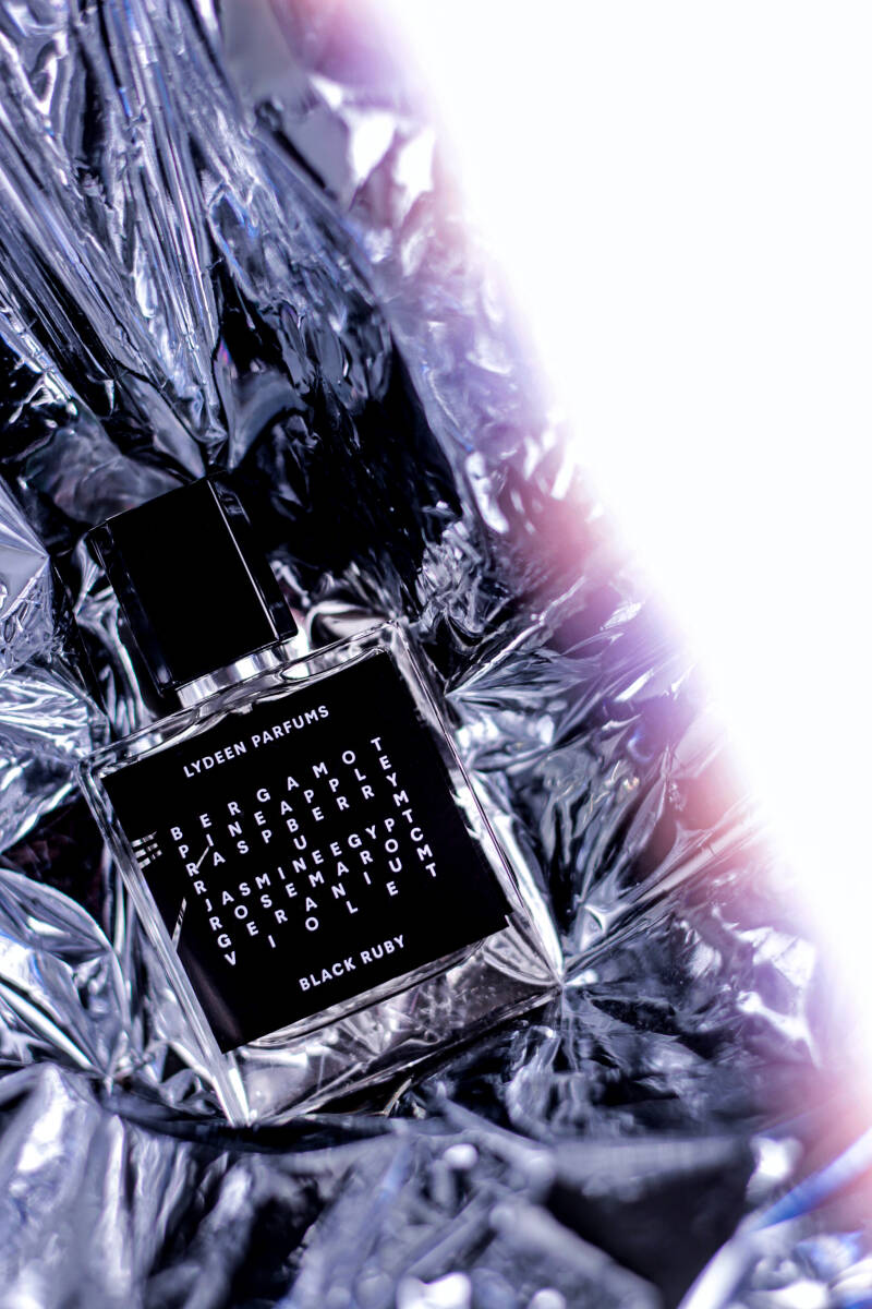 1. Black and white perfume label against a shiny backdrop