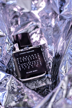 3. Lydeen Parfums bottle surrounded by shimmering textures