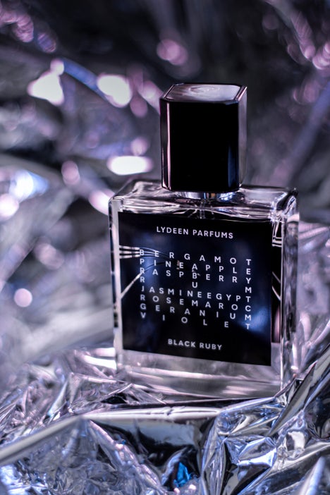 1. Black perfume bottle with white text in a metallic setup