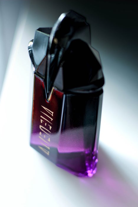 Luxurious Mugler fragrance bottle captured in moody lighting β Alien Extraintense EDP