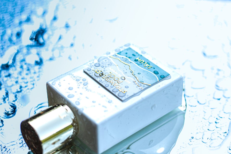 Artistic shot of Strawberry Pool perfume with poolside effect