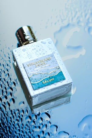 Strawberry Pool perfume on a surface simulating a swimming pool