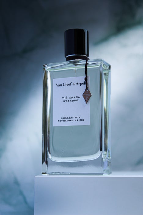 Minimalist shot of Thé Amara by Van Cleef & Arpels, showcased on a pedestal with a dreamy, atmospheric backdrop.