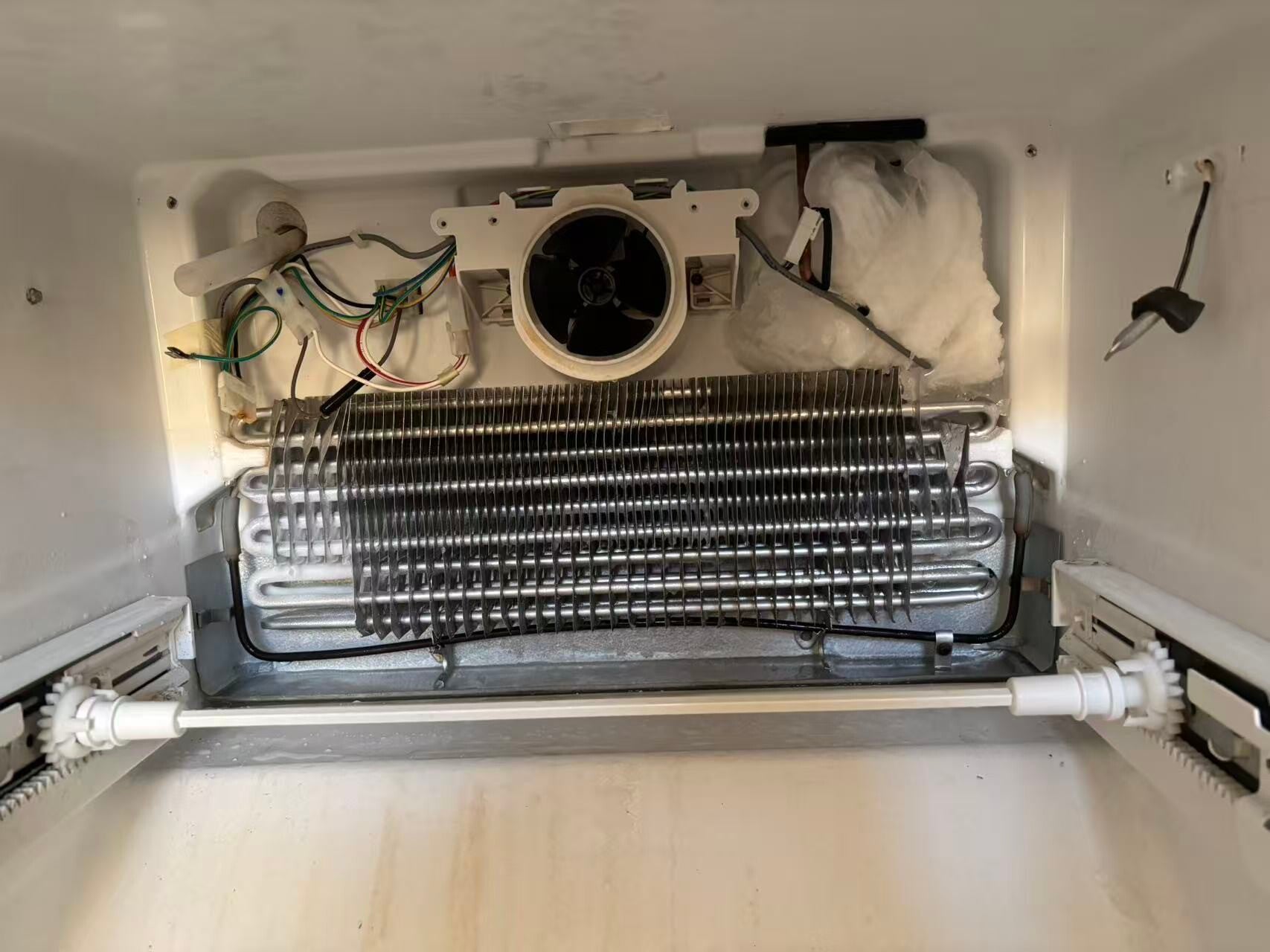 Appliance technician repairing a refrigerator in Oakville