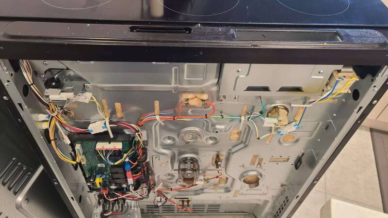 Appliance technician repairing oven in Milton